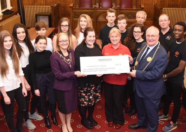 The Mayor and Mayoress of South Tyneside, Coun Richard Porthouse and his wife Patricia, present pupils and teachers from St Wilfrids RC College with a cheque.