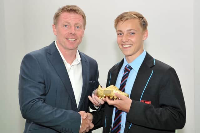 Harry Chapman, right, being presented with an award by Craig Hignett