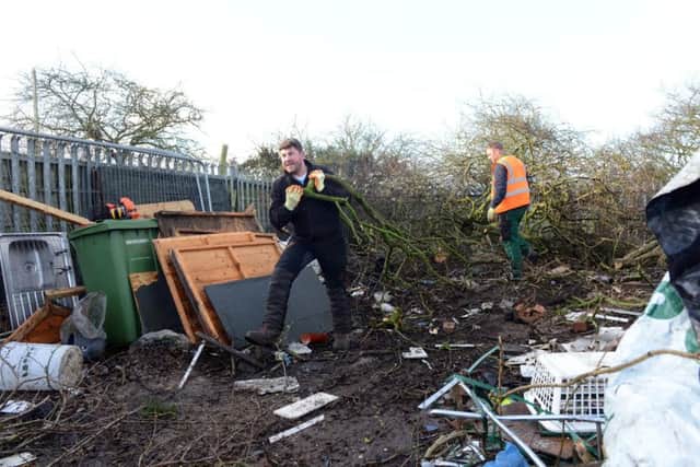 David Hind of Deerness Esh Group helps with the clean-up of the trashed allotment.