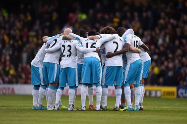 The Newcastle United players huddle together for a team talk before the game at Watford