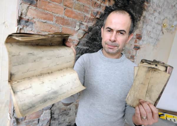 Scott Carlucci and the papers which were found in the chimney.