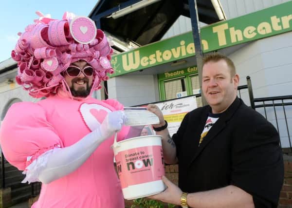 Laffalang producer Gareth Hunter hands cash for Breast Cancer Now to Big Pink Dress man Colin Burgin-Plews.