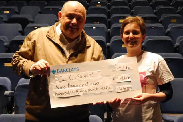 Ray Spencer hands a cheque to Dee Tyler, area fundraising manager for CLIC Sargent.