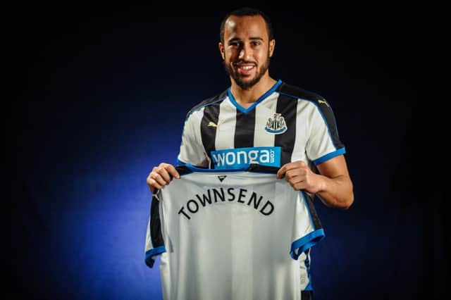 Andros Townsend poses with his new Newcastle shirt after joining the Magpies