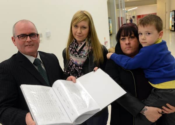 Michelle Walters hands in a petition calling for Wenlock Road to be made safer to Coun Michael Clare. Also pictured are Rachel Moreton and Jack Moreton, aged five.