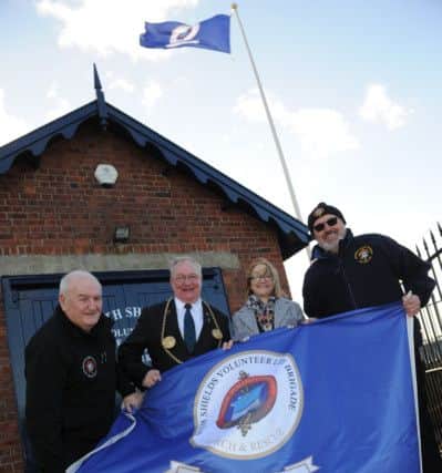 The Mayor Coun Richard Porthouse and Mayoress Patricia Porthouse join South Shields Volunteer Lifebrigade members Tom Fennelly and Norman Jenson, to raise the 150th anniversary flag.