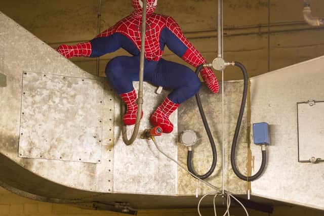 A giant stuffed Spiderman toy sits on an air duct, among the items at the Transport for London Lost Property Office, which sorts and stores the items left on the capital's public transport system.