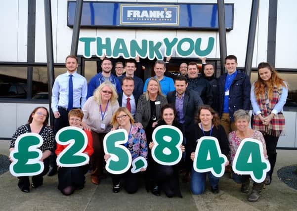 Frank's the Flooring Store staff presenting Michelle Muir of Macmillan Cancer Support with their Â£25,844 donation. Pic: Keith Taylor.