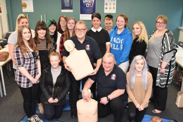 CPR trainers Malcolm Dunn, standing front, and Joe Welsh, with lecturer Claire Robinson, standing centre, and other staff and students.