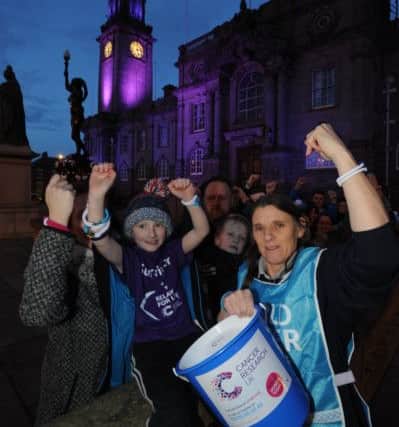 Ann Walsh joins Charlie Mordey with parents Angela and Chris, and supporters outside South Shields Town Hall, which was illuminated purple to mark World Cancer Day.