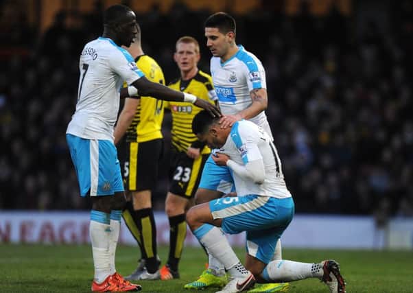Jamaal Lascelles (kneeling) celebrates his goal against Watford with his Moussa Sissoko (left) and Aleksandar Mitrovic