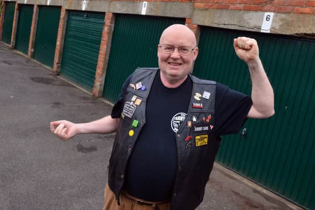 Disabled biker Paul Kelly has won his nine-month fight for a new garage.