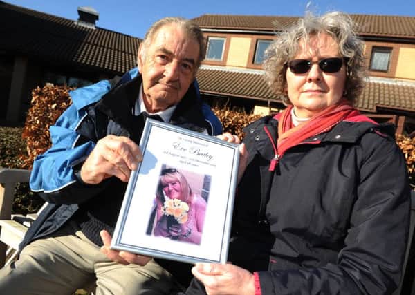 Falstone Avenue residents Jim Pennock and Edith McGillivray with the tribute to Eve Bailey they were asked to remove from their community hall.