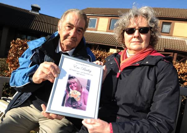 Falstone Avenue residents Jim Pennock and Edith McGillivray with the tribute to Eve Bailey they were asked to remove from their community hall.