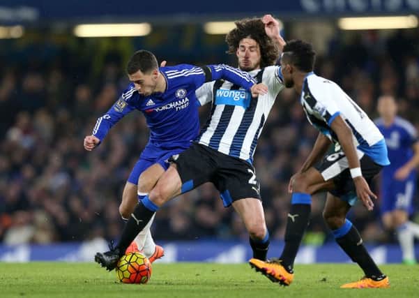 Newcastle United's Fabricio Coloccini battles with Chelsea's Eden Hazard.