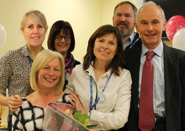 Marilyn Wilkinson, holding flowers, with , left to right, Ultrasound Manager Jayne Richardson, Clinical Business Manager Bronia Fleet, Radiology Service Lead Karen Green and Consultant Radiologists Dr Oliver Schulte and Dr Lance Cope.