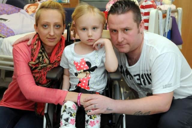 Jessica Bootes with mum Lisa and dad Chris in hospital after the smash which injured her.