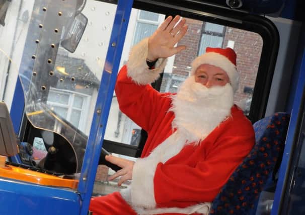 Kenny Ramsay dressed as Santa on his bus.