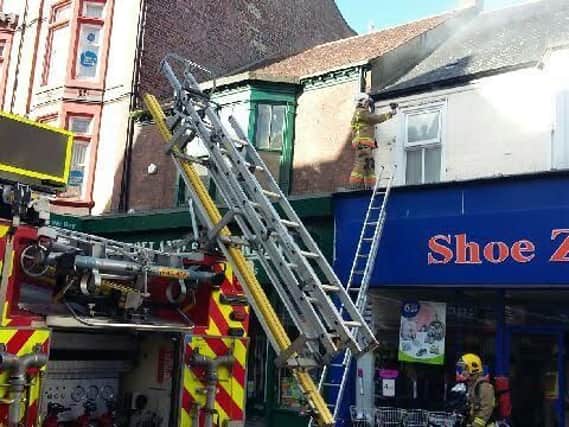Firefighters deal with a fire in the flat above Shoe Zone in South Shields