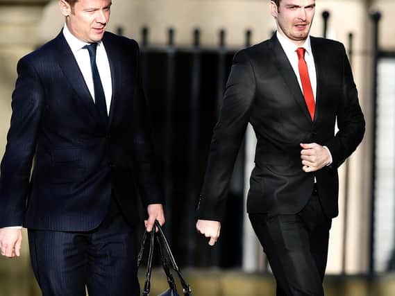Footballer Adam Johnson (right) arrives with an unidentified man at Bradford Crown Court for the start of the defence at his trial where he is accused of sexual activity with a child.