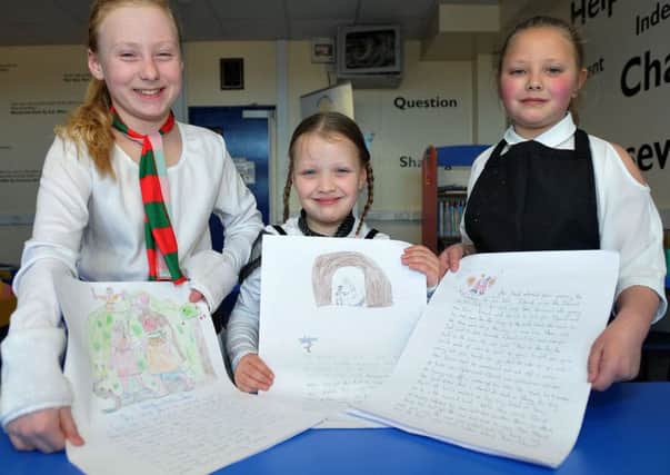 Youngsters Lacy May Burridge, Jessie Davies and Maddison Scott with their Codex drawings.