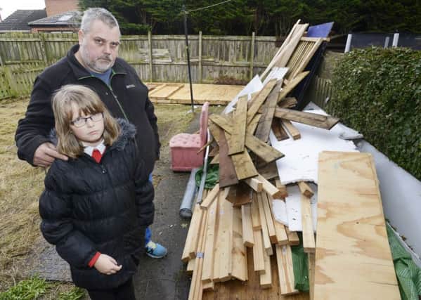 Vincent Pool and his daughter Louise with material for the shed they want in their back garden.