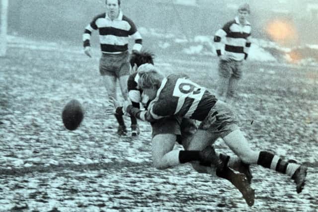 Bill Parker diving into action on the rugby field.