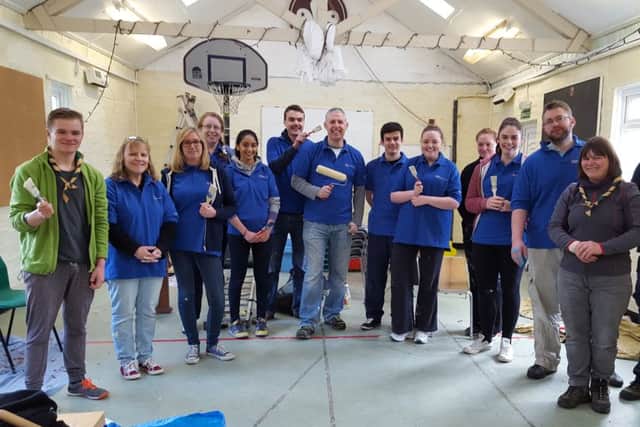Cub leader Jack White, far left, with volunteers and scout leaders at the newly repainted Scout Hut.