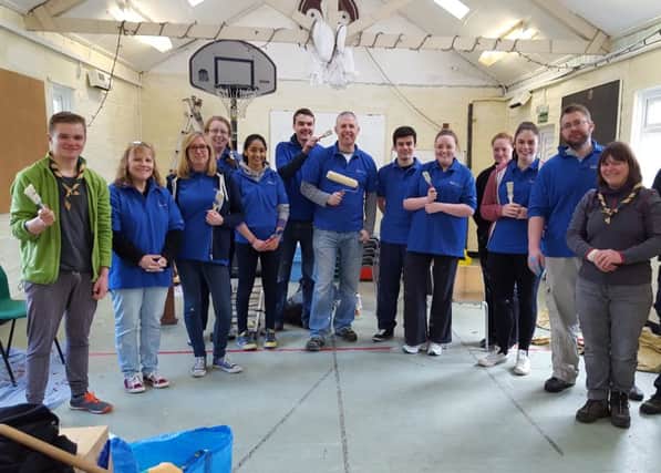Cub leader Jack White, far left, with volunteers and scout leaders at the newly repainted Scout Hut.