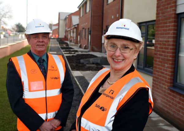 Councillor Norman Dick and Councillor Gladys Hobson pictured outside the new housing at the West Way site.