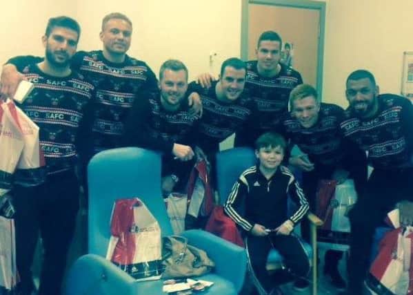Drew Broderick with Sunderland AFC team members when they visitied the Royal Victoria Infirmary, in Newcastle, at Christmas.
