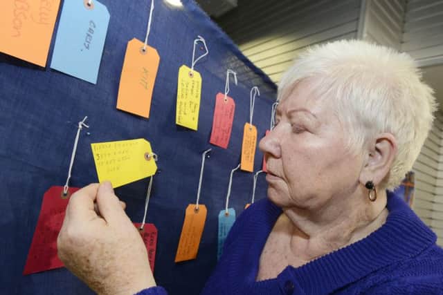 Margaret Shaw with the prayer wall in the West Harton Church Easter shop in South Shields town centre.