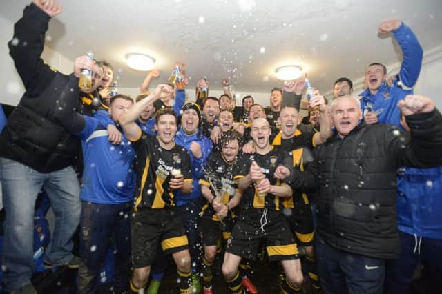 Morpeth Town celebrate their FA Vase semi-final victory in the dressing room after the match
