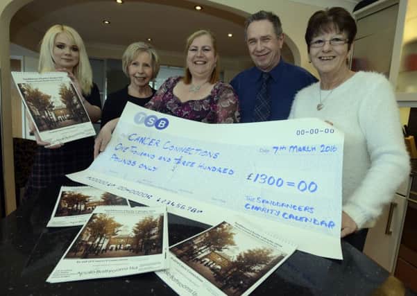Ellen Milne, Jim Robertson and Meg Taylor from the Sanddancers Charity Calendar hand Â£1300 to Kathryn Cox (left) and Brenda Errington (right) from Cancer Connections.