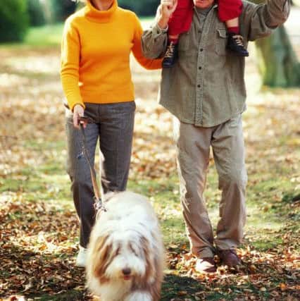 Grandparents walking their dog with their granddaughter. PA Photo/thinkstockphotos