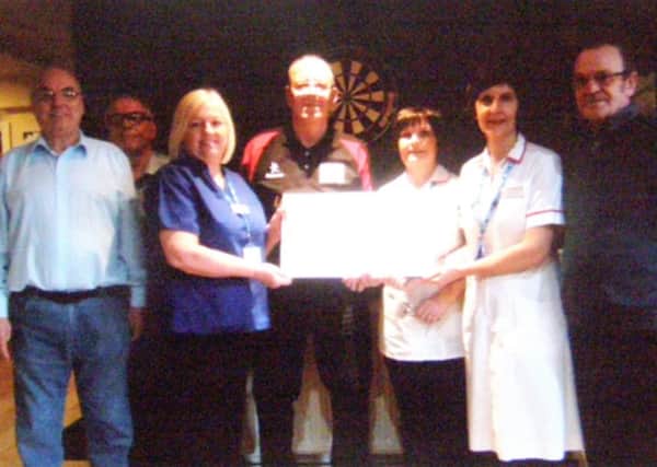 Representatives from the darts marathon with staff from South Tyneside District Hospital's cardiac unit.  From left, Ernie Metcalf, John Wilkinson, Alison Jones, Jim Taroni, Maureen Amess, Suzanne Appleby and John Maughan.