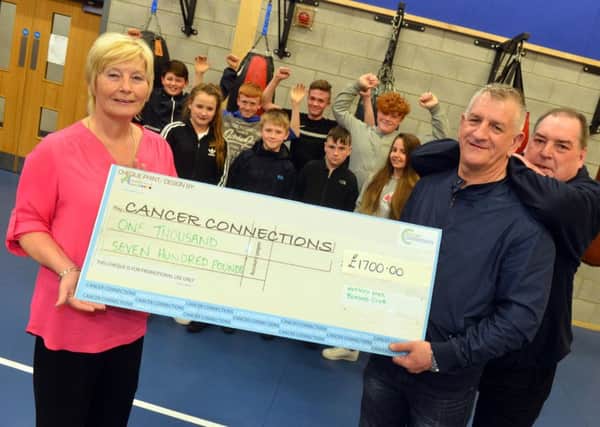 Deborah Roberts receives funds from Stevie Winter and Horsley Hill Youth Services George Pearce, right.