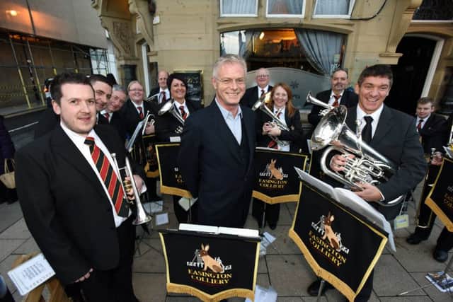 Director of Billy Elliot - The Musical Stephen Daldry with Easington Colliery Brass Band playing outside of the Sunderland Empire.