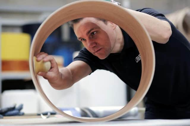 Andrew Street sanding the inside of a drum at Liberty Drums premises. Picture by Stuart Boulton.