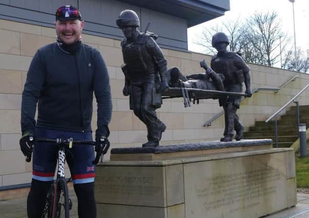 Stuart Redmond getting some cycling practice in before he starts a 320-mile trek.