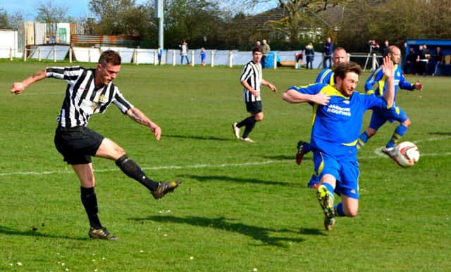Ashington striker Damien Stevens scores in his side's 3-0 success at Jarrow Roofing. Picture by Ian Appleby