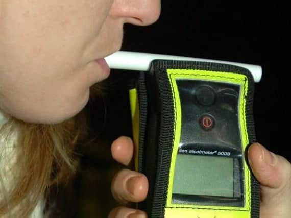 A woman being breathalysed.