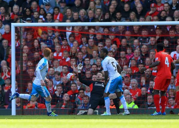 Jack Colback, left, sees his shot go in via a deflection to score Newcastle Uniteds equalising goal at Anfield.