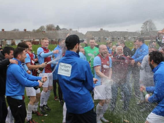 South Shields' players soak each other with champagne after their title victory. Image by Peter Talbot.