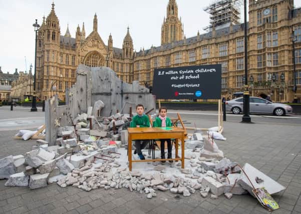 A mock-up of a destroyed classroom outside the Houses of Parliament at a Save the Children event ahead of a London Syria Conference earlier this year. Dominic Lipinski/PA Wire
