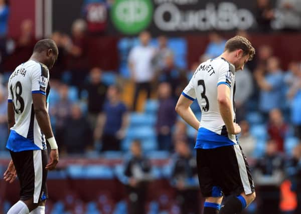Down and out? Newcastle Uniteds Chancel Mbemba (left) and Paul Dummett leave the field dejected after the whistle at Villa Park