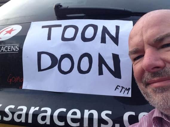Neil Cain with the posters stuck on Joe Shaw's car.