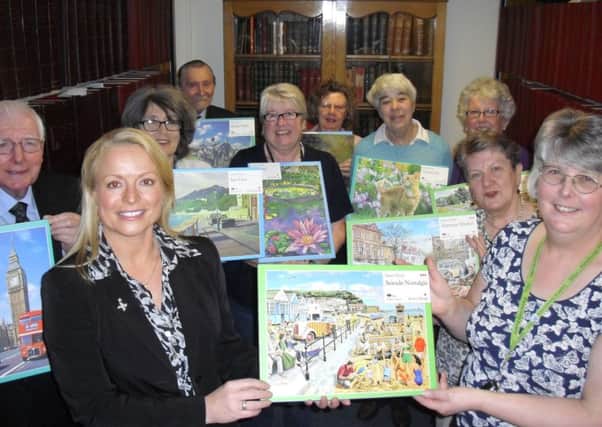Julie Lightfoot, Solar Solve Marine Managing Director presents jigsaws to the Supporters of South Tyneside Libraries Group.