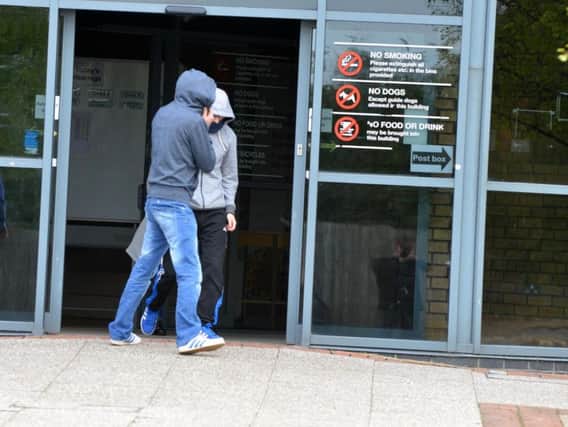 Paul Dixon (in grey top and black trousers) leaves South Tyneside Magistrates' Court after being charged with a string of cyber hacking offences.