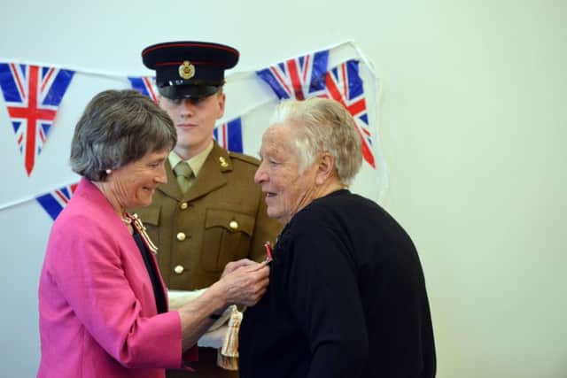 Anne Seymour is presented with the MBE by the Lord Leiutenant of Tyne and Wear Sue Winfield
